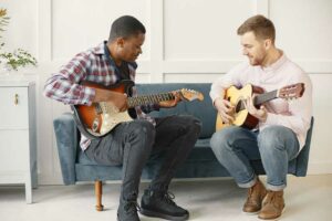 Music Lessons in Randburg. picture of two teenage boys practicing guitar